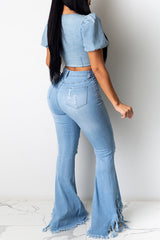 Vaqueros acampanados lavados con flecos rotos