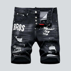 Black inscribed ripped denim shorts