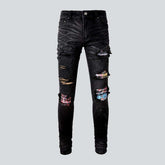 Patchwork-Bikerjeans mit Graffiti-Print