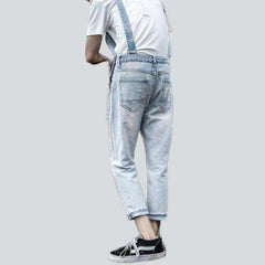 Light wash distressed denim jumpsuit