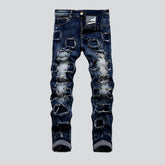 Mit Nieten verzierte Flicken-Jeans für Herren