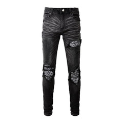 Schwarze zerrissene Vintage-Bikerjeans