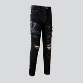 Zerrissene Herrenjeans mit Schlangenstickerei