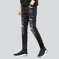 Slightly ripped black men jeans