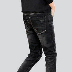 Slightly ripped black men jeans