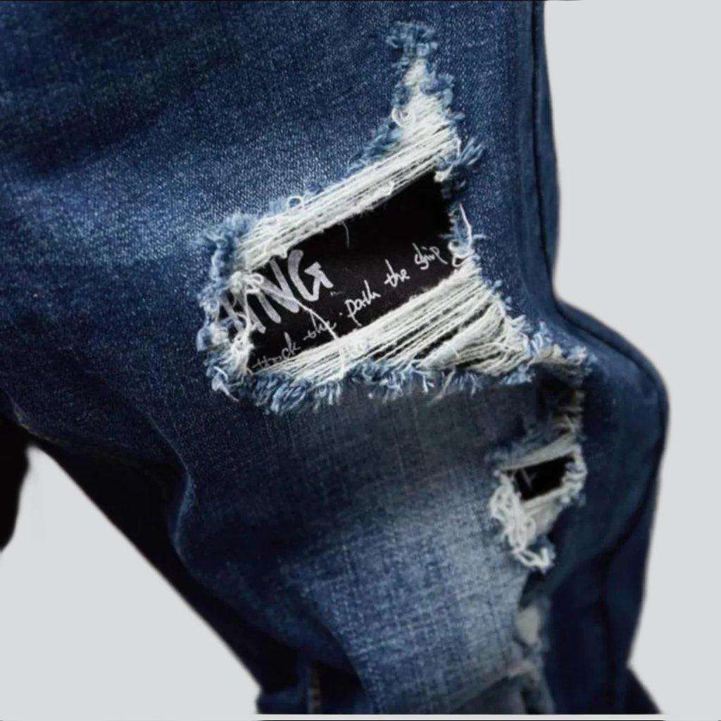 Destroyed blue jeans for men