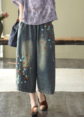 Pantalones vaqueros anchos con agujeros y bordados en color oscuro, cómodos