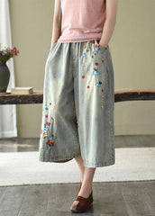 Pantalones vaqueros anchos con agujeros y bordados en color oscuro, cómodos