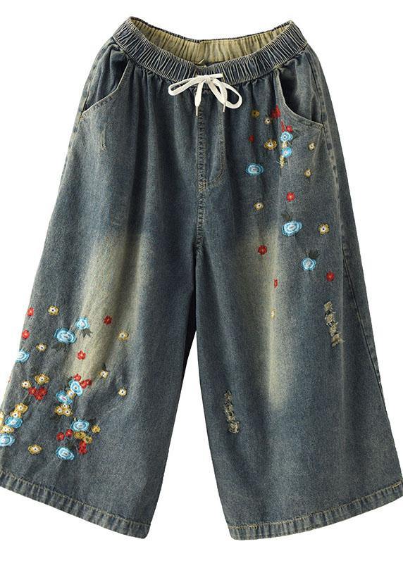 Pantalones vaqueros anchos con agujeros y bordados en color oscuro, cómodos
