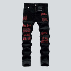 Corduroy jeans with red inscriptions