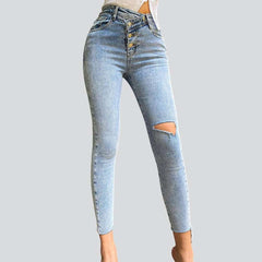 Exposed asymmetric button women jeans