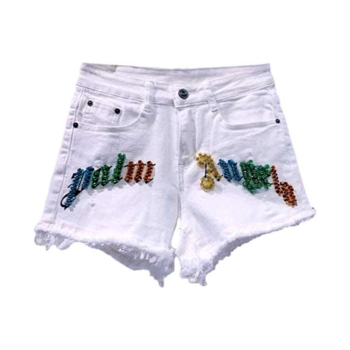 Shorts vaqueros desgastados con inscripción de cristal