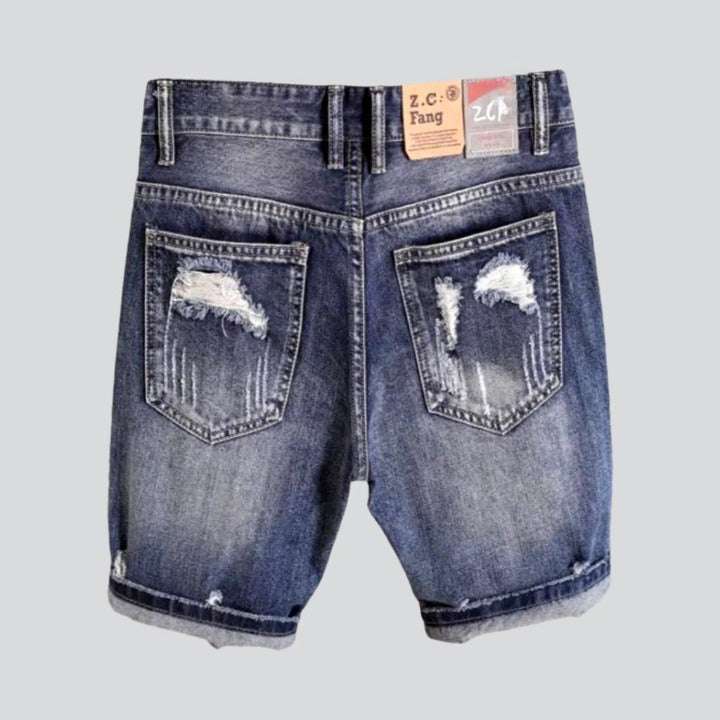 Shorts vaqueros desgastados con parche grabado