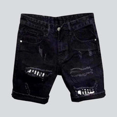 Inscribed patches distressed denim shorts