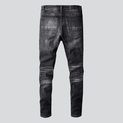 Whiskered distressed black men jeans