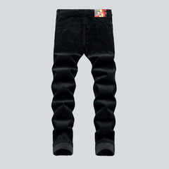 Corduroy jeans with red inscriptions