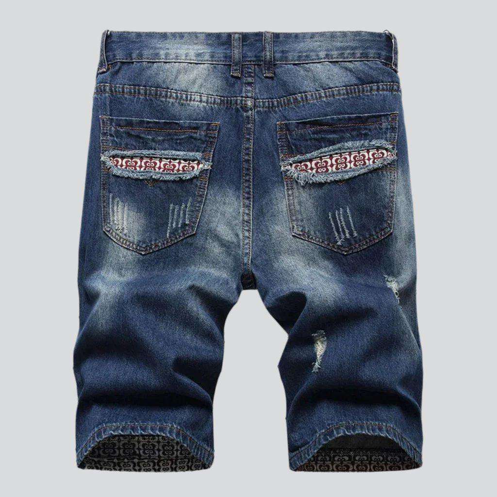 Mid-wash distressed denim shorts