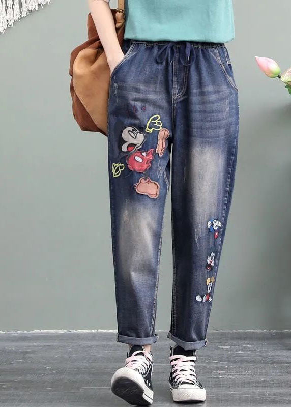 Einzigartige blaue Patchwork-Jeanshose mit Cartoon-Stickerei und Taschen